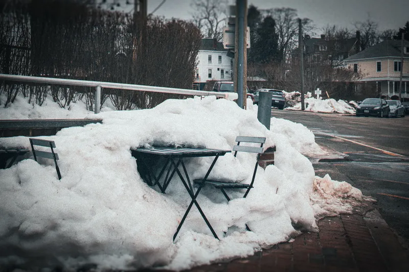 A chair covered in fresh snow